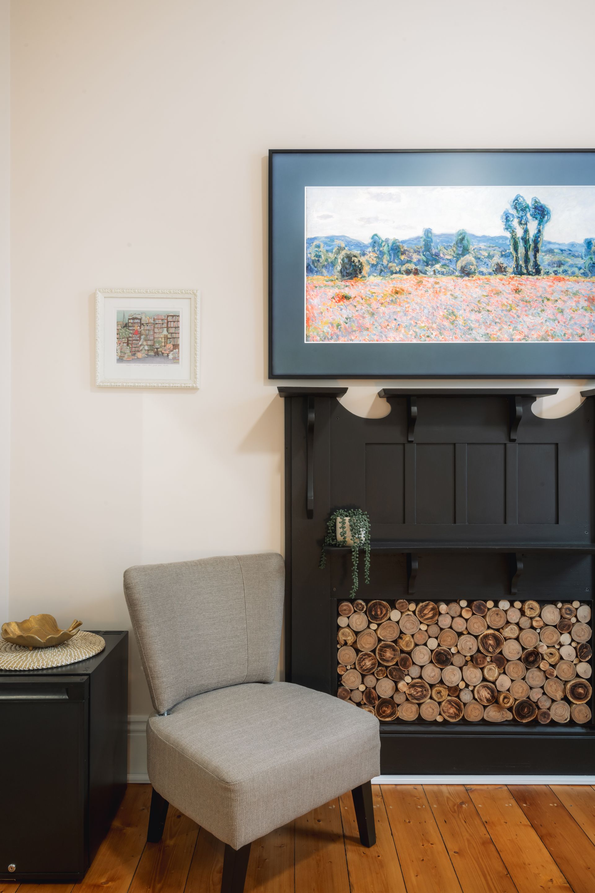 A chair is sitting in front of a fireplace in a living room.