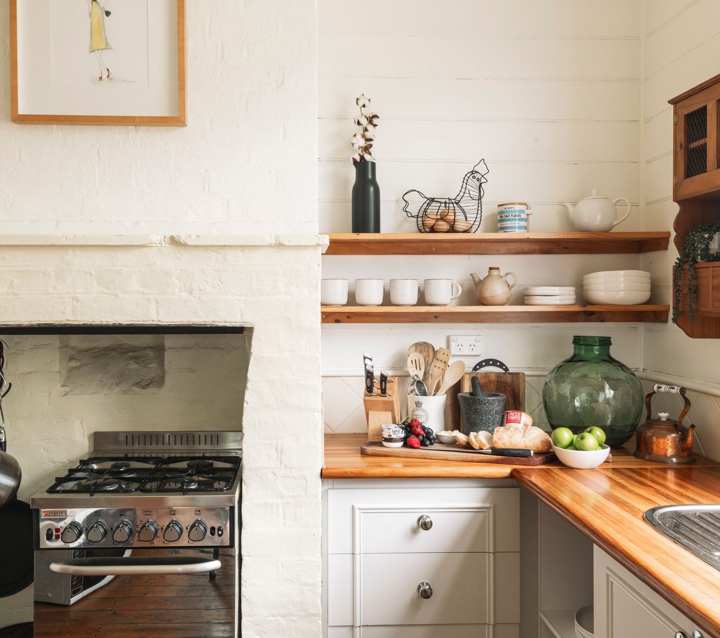 A kitchen with a stove top oven and a fireplace