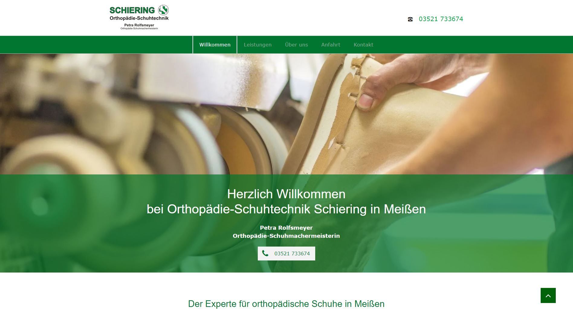 Person, die an einem Schuh mit grünem Firmenlogo arbeitet.