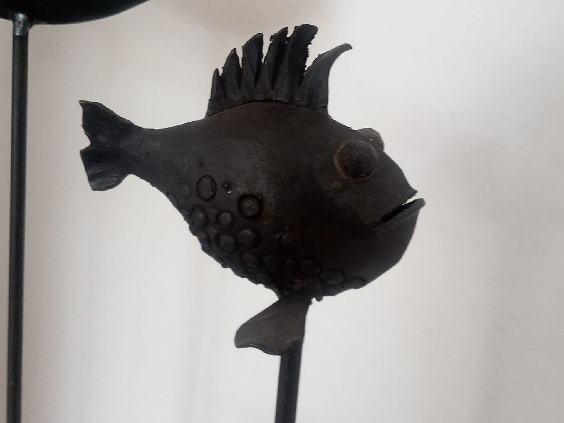 Metallskulptur eines Fisches auf Stab