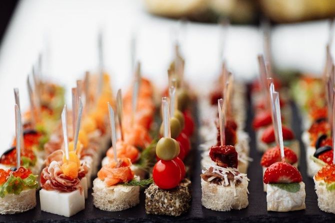 Una mesa cubierta con una variedad de aperitivos en palillos de dientes.