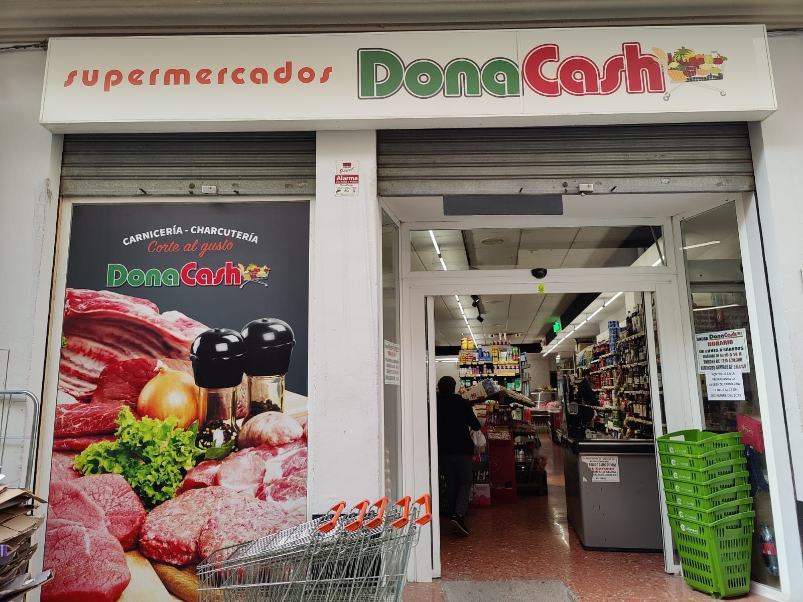 Un escaparate con un cartel que dice supermercados dona cash