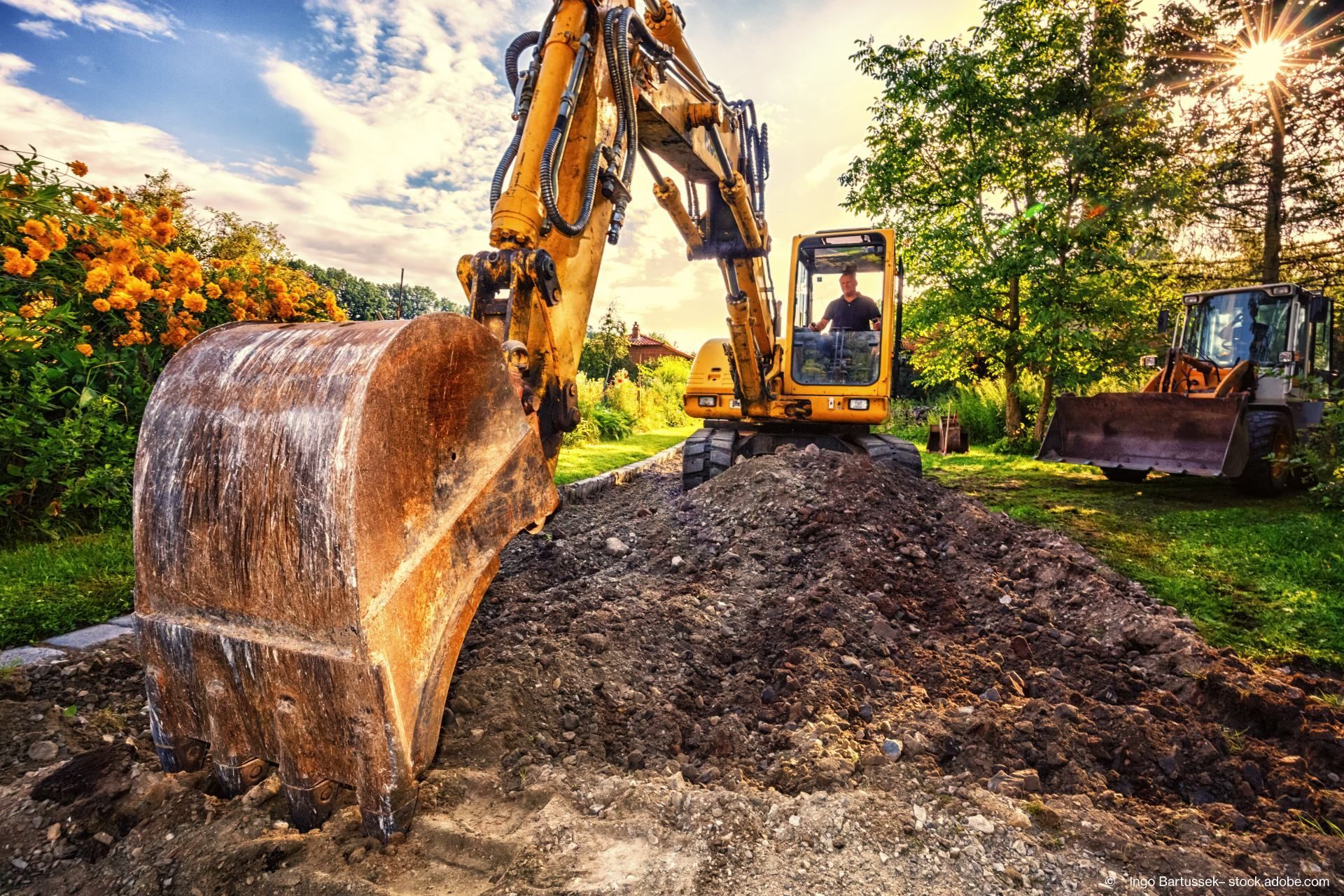 Weitwinkel von einem Bagger, welcher Erde schaufelt