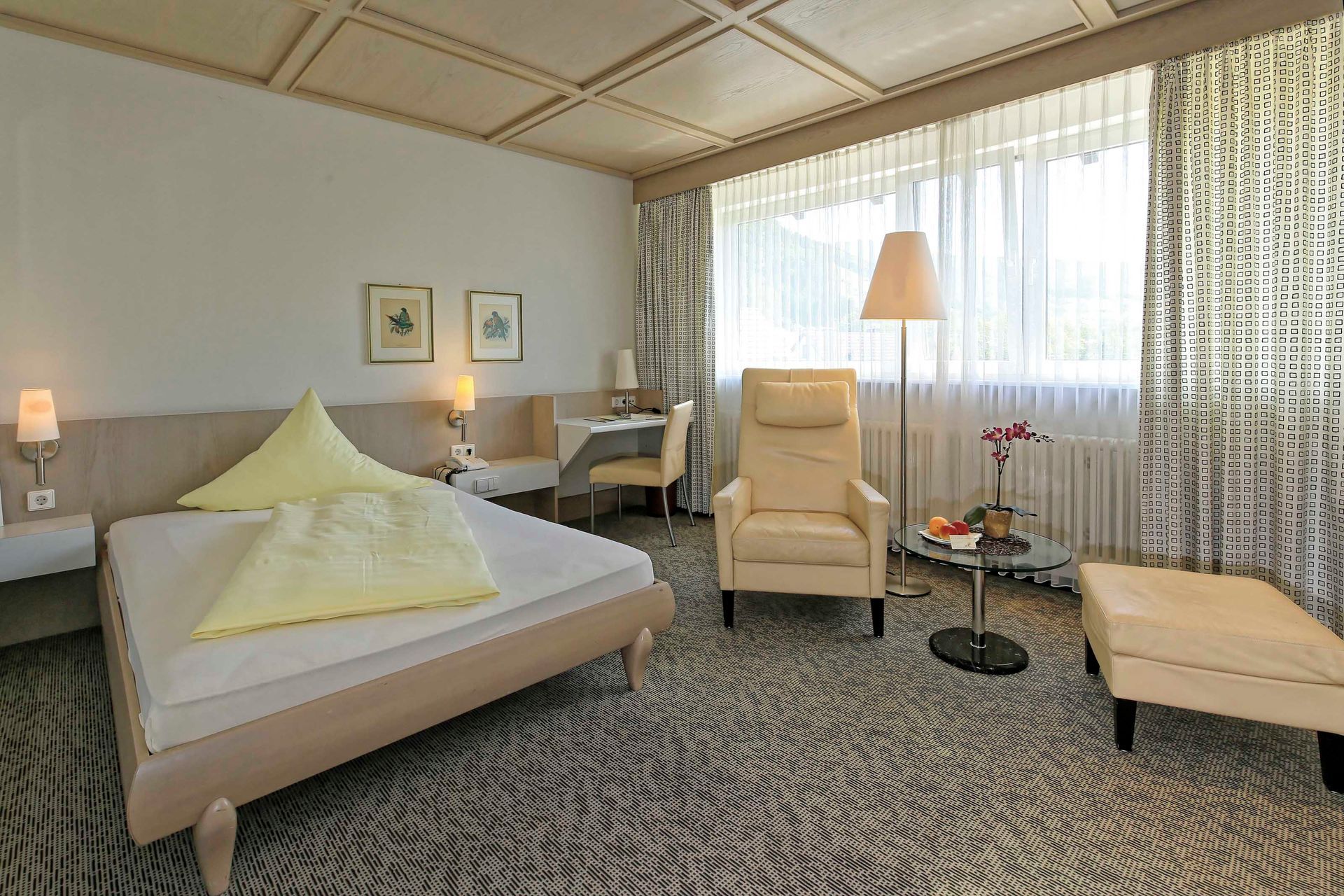 Ein Hotelzimmer mit Bett, Stuhl und Tisch