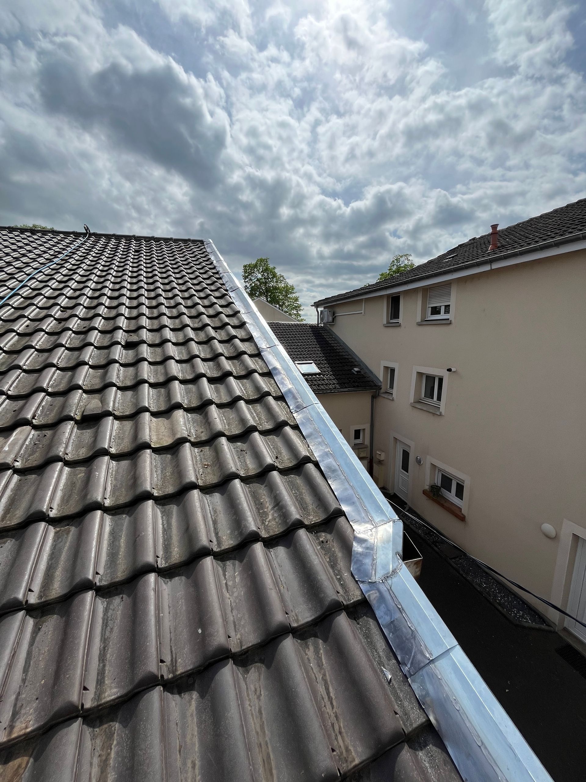 Tôle de rive sur un toit en tuiles