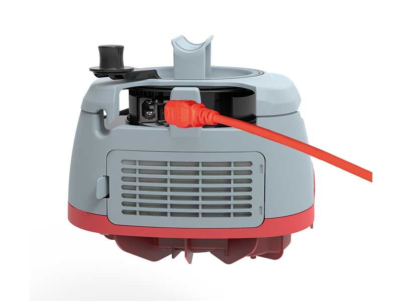 Ein Staubsauger mit einem daran befestigten roten Kabel