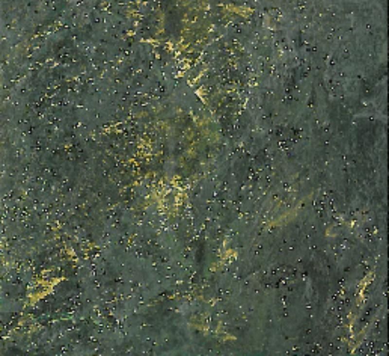 Un primo piano di una piastrella verde con macchie dorate
