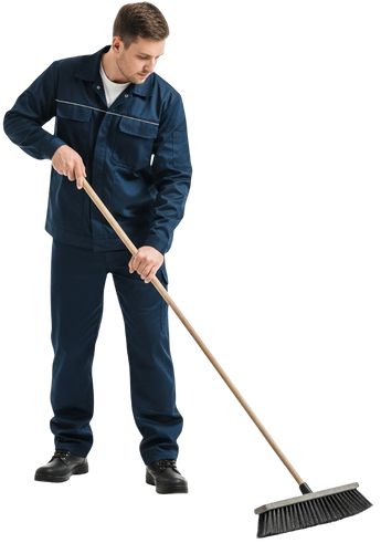 Un homme en costume de travail bleu avec un balai.