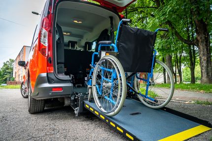 Un fauteuil roulant sur une rampe pour entrer dans un fourgon
