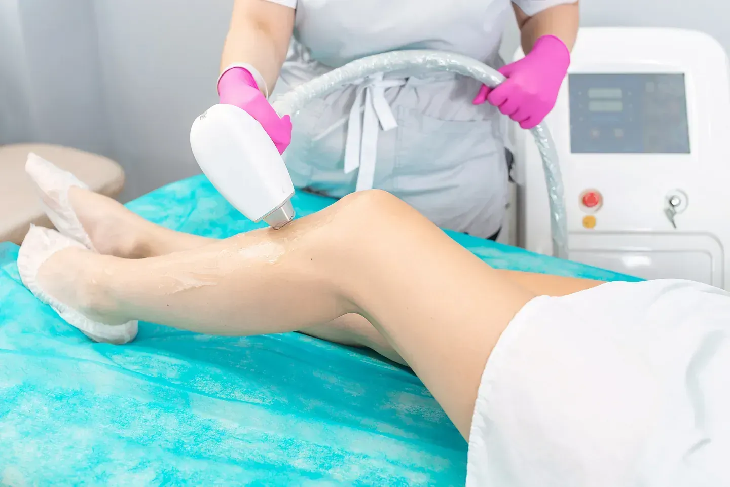 Una mujer está recibiendo un tratamiento de depilación láser en las piernas.