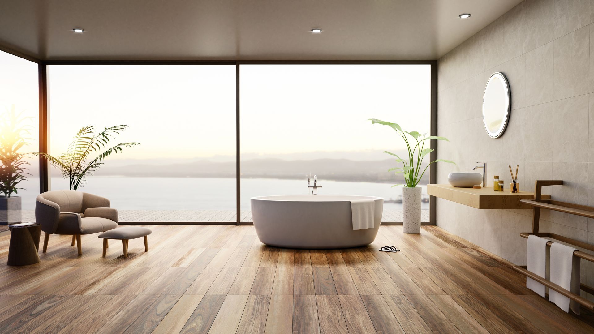 Salon minimaliste baigné de lumière naturelle avec de grandes fenêtres, une baignoire, un parquet, un fauteuil et des plantes en pot.