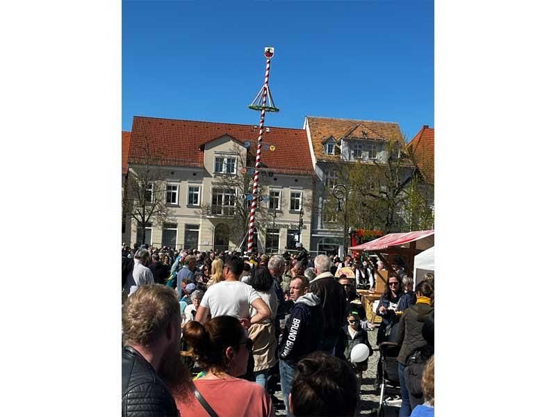 Eine Menschenmenge hat sich auf einem Platz vor einem Gebäude versammelt.