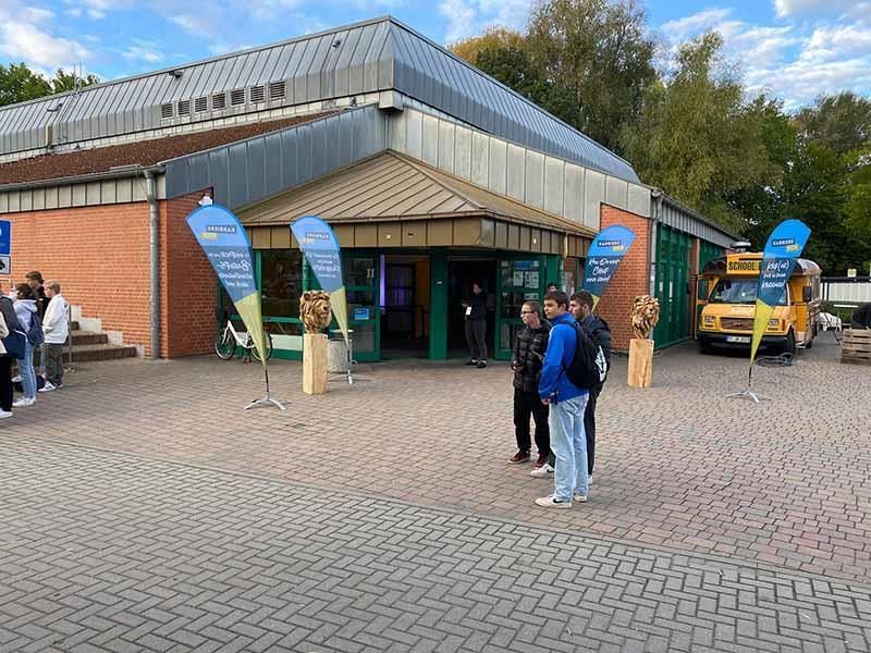 Eine Gruppe von Menschen steht vor einem Gebäude.