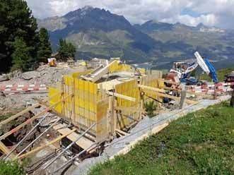 Eine Baustelle in den Bergen mit Blick auf die Berge im Hintergrund. Foto von der H. Kuhn Hoch- und Tiefbau AG