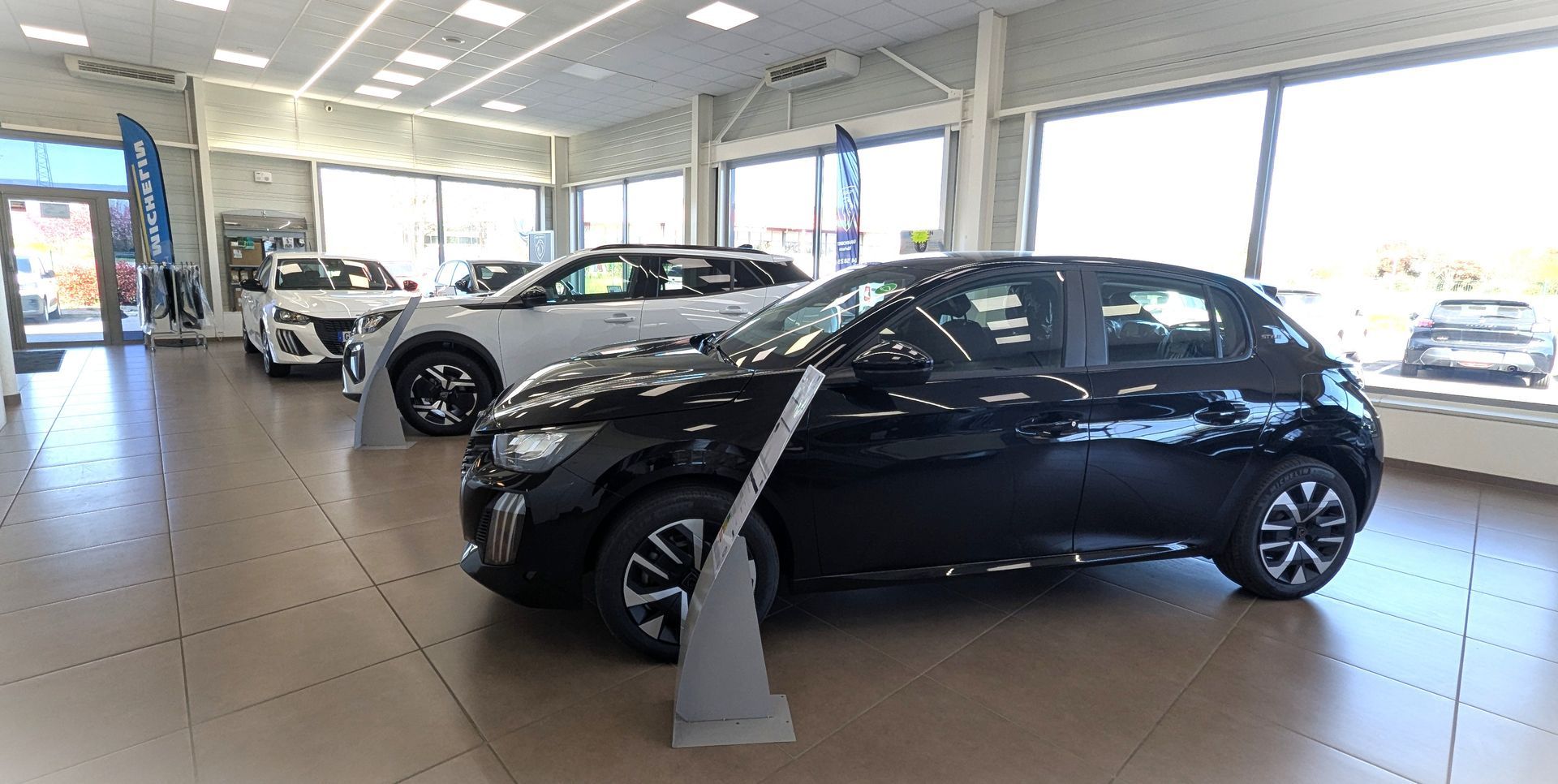 Véhicules exposés dans l'entrée d'un concessionnaire.