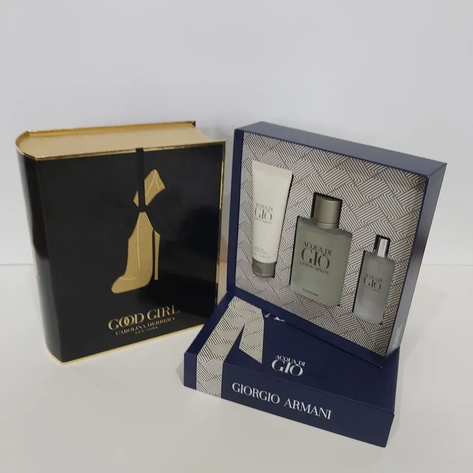 Un conjunto de perfumes Good Girl y Giorgio Armani.