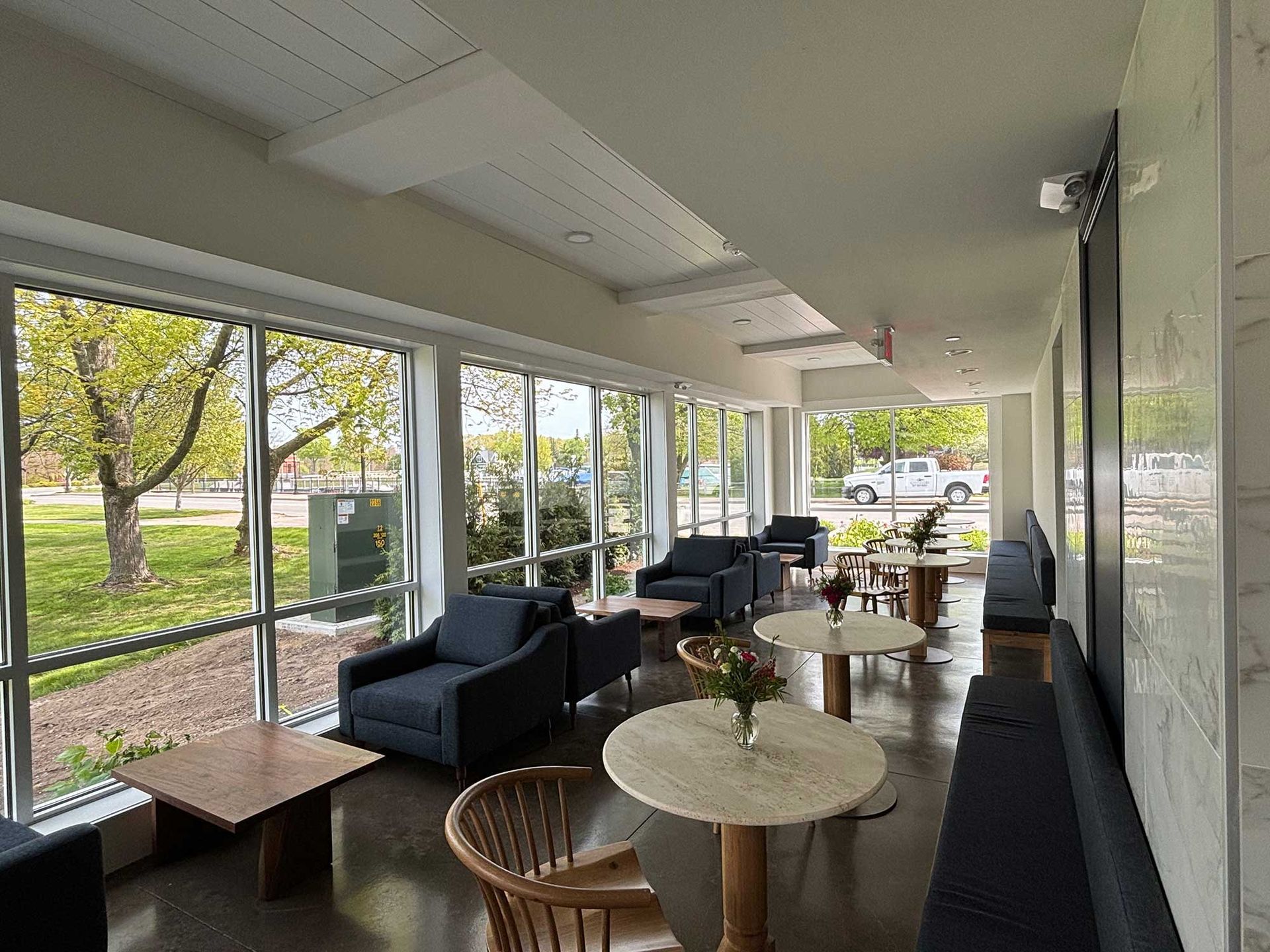 Lounge with tables, chairs, and other seating.