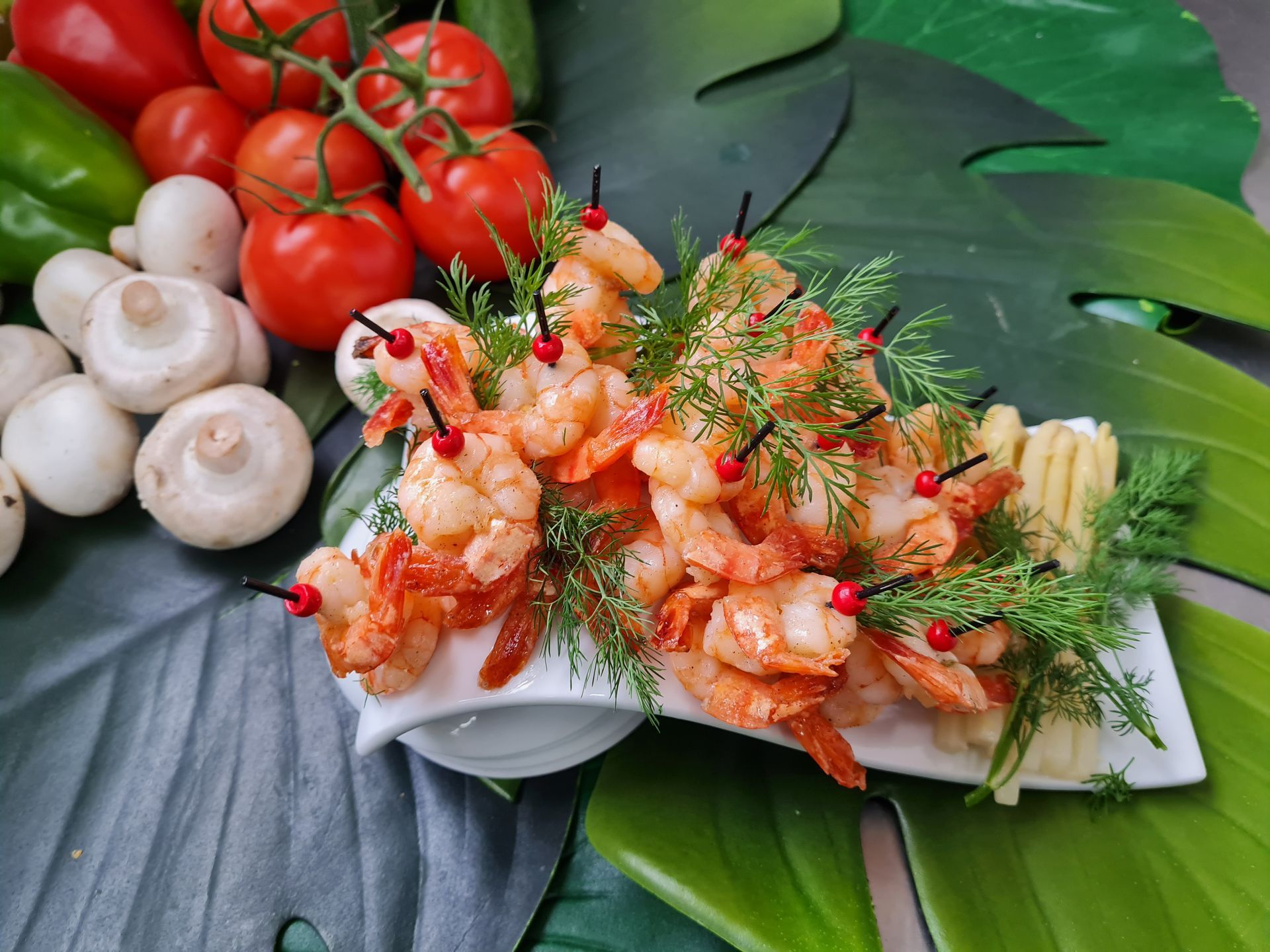 Ein Teller mit Essen mit Tomaten und Mozzarella auf Zahnstochern