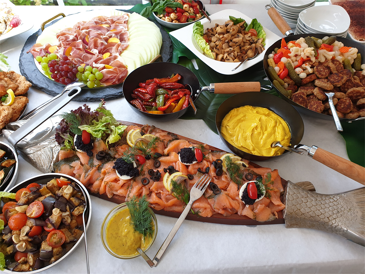 Ein Buffettisch mit einem großen Stück Lachs darauf