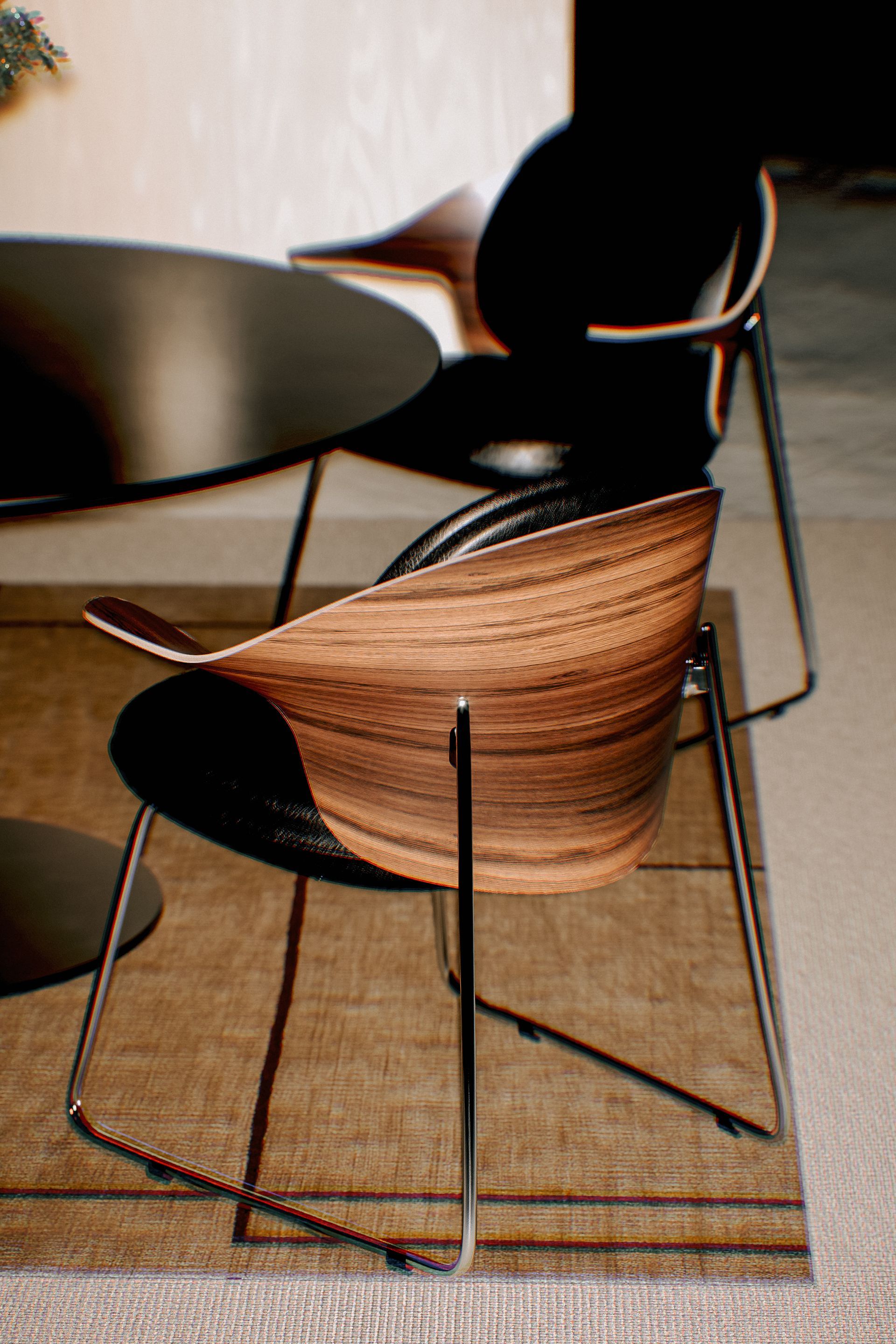 Eine moderne Essumgebung: ein schwarzer runder Tisch, zwei Stühle mit Holz- und Metallelementen auf einem braunen Teppich.