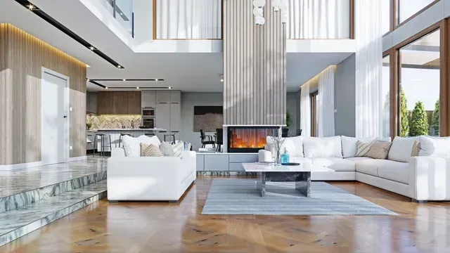 Moderna sala de estar de lujo con sofás blancos, chimenea y grandes ventanales con vistas a un interior luminoso.