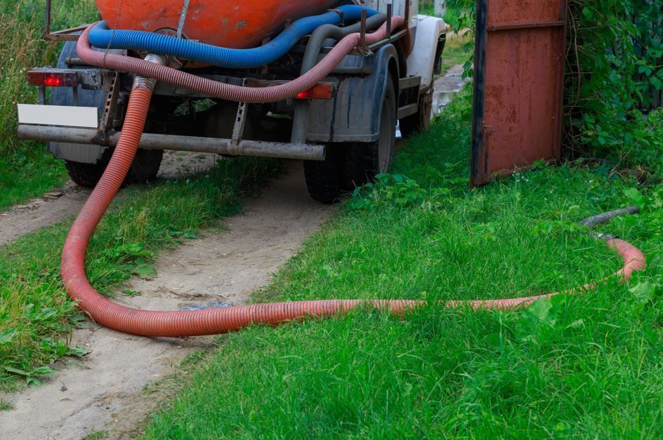 Un camión cisterna para aguas residuales con una manguera.