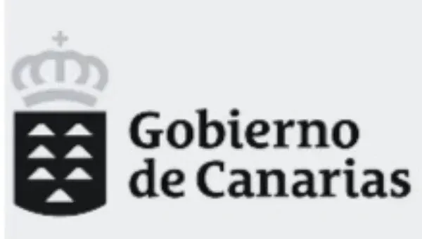 Logotipo del Gobierno de Canarias con escudo negro y corona gris sobre fondo blanco.