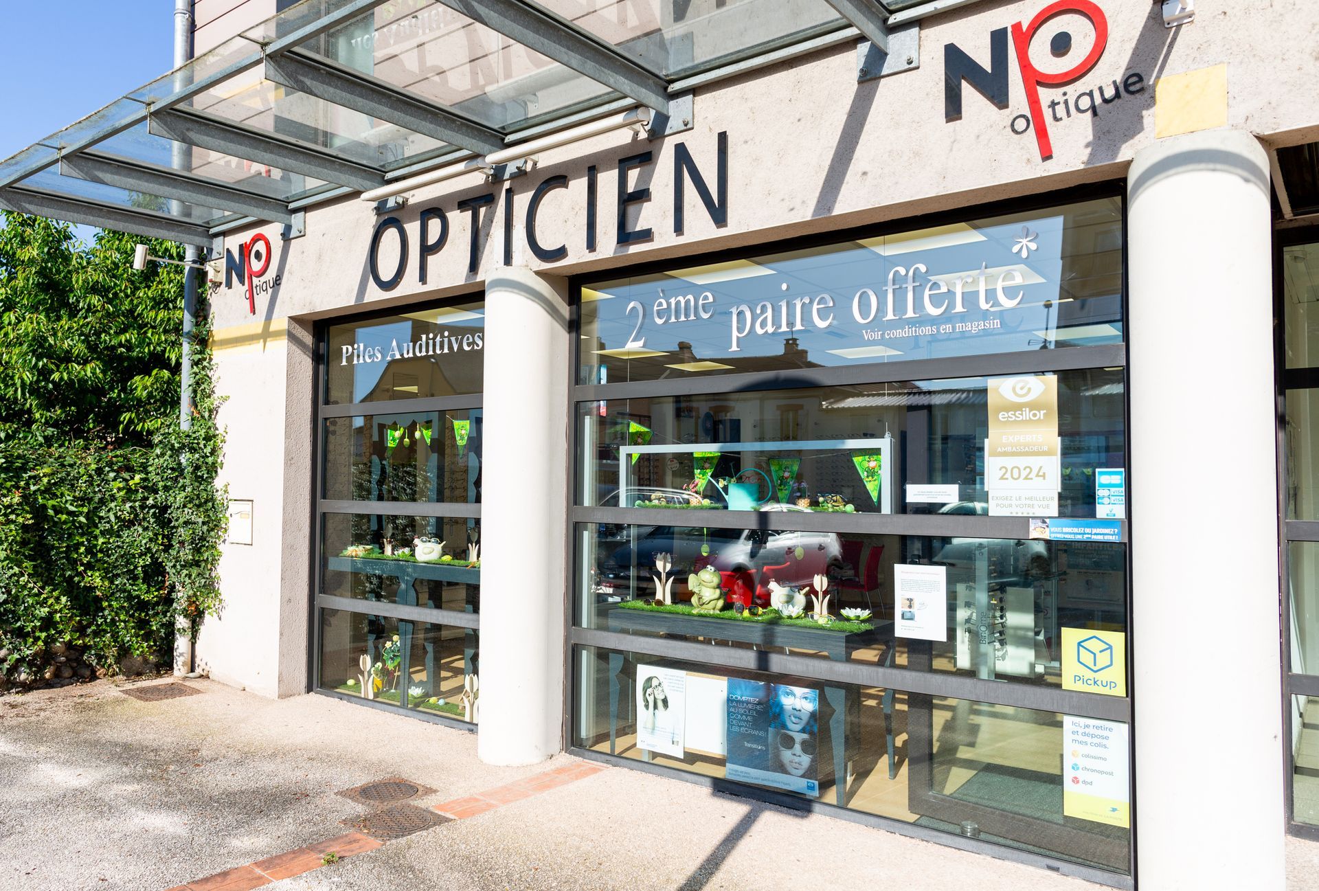Façade d'opticien avec vitrines, colonnes blanches et enseignes