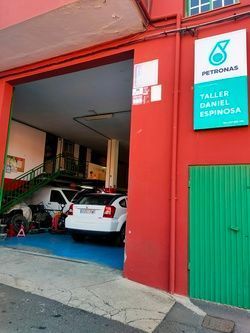 Un edificio rojo con una puerta verde y un cartel que dice 