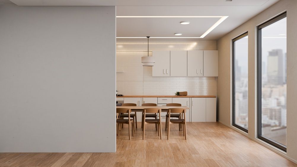 Cocina y comedor modernos y luminosos con suelos de madera y grandes ventanales con vistas al horizonte de la ciudad.