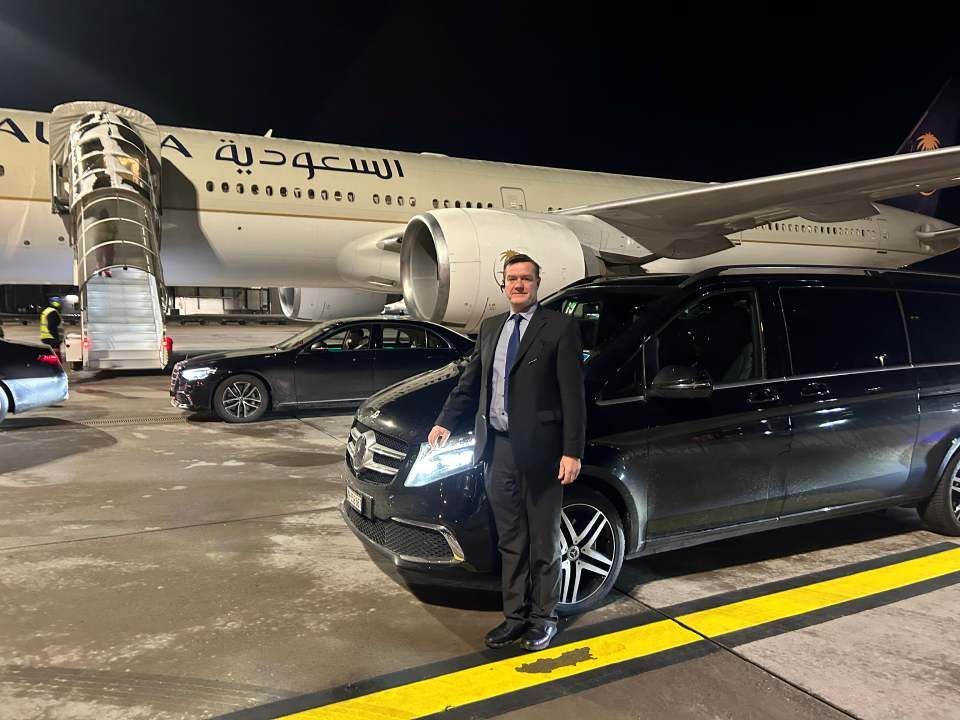 Two men carry boxes out of a delivery van.