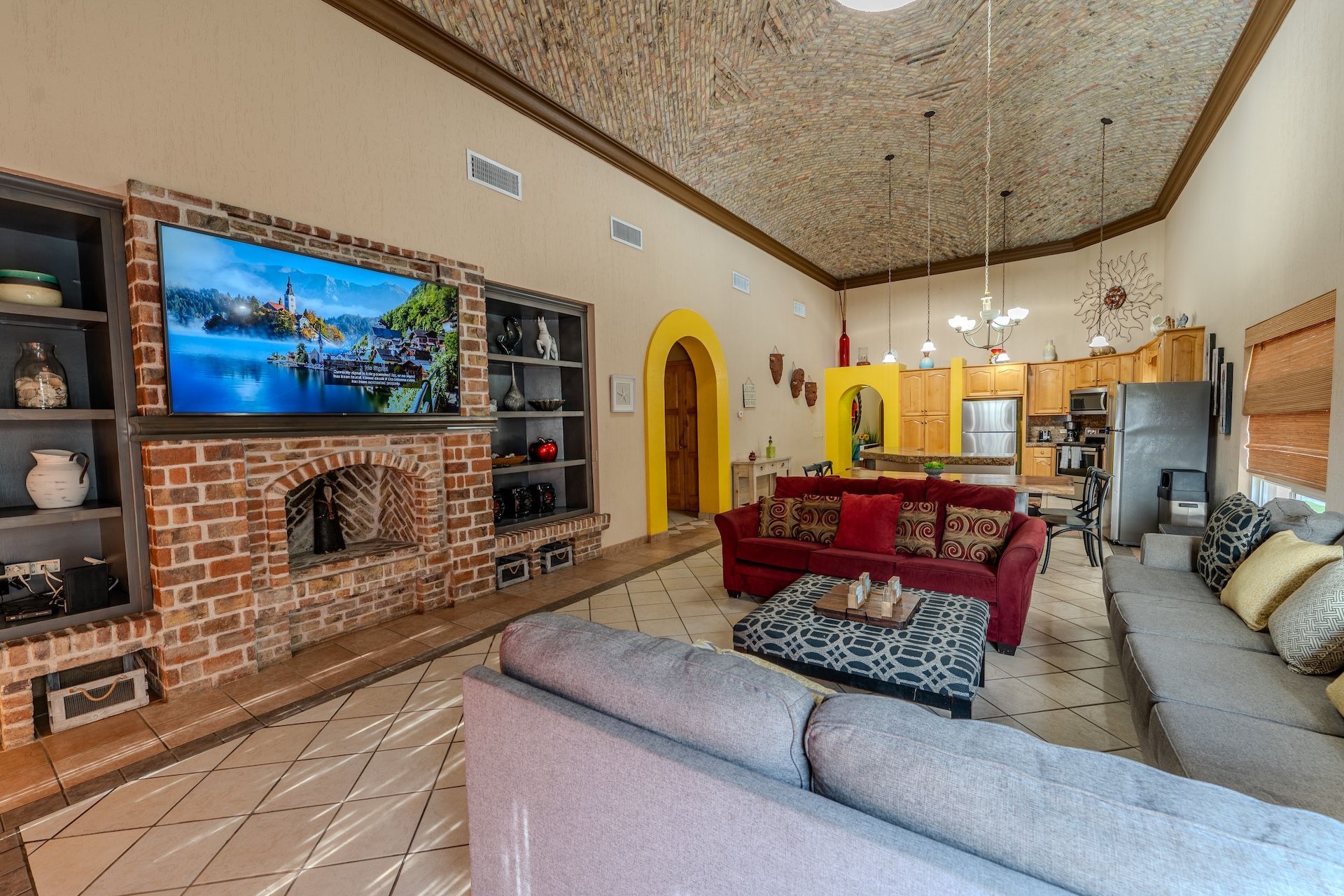 Oceanfront resort view with pool, cabanas, white buildings, and blue sky.