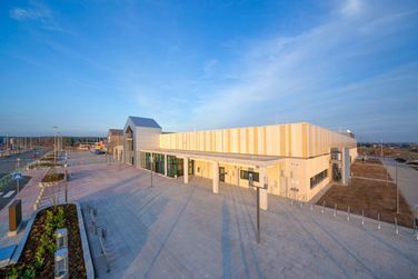 Eine Luftaufnahme eines großen Gebäudes mit einem blauen Himmel im Hintergrund.
