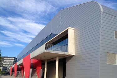 Ein großes Gebäude mit einem Balkon an der Seite.