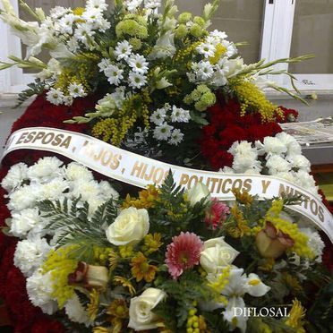 Funeral wreath with a ribbon reading