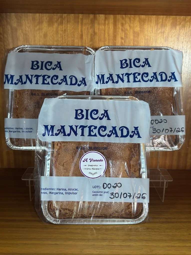 Tres panes envasados con la etiqueta “Bica Mantecada” en el estante de una tienda.