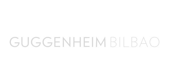 Texto gris claro con la inscripción “GUGGENHEIM BILBAO” sobre fondo blanco.