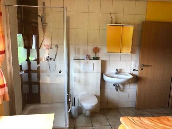 Badezimmer mit Ganzglasdusche und WC