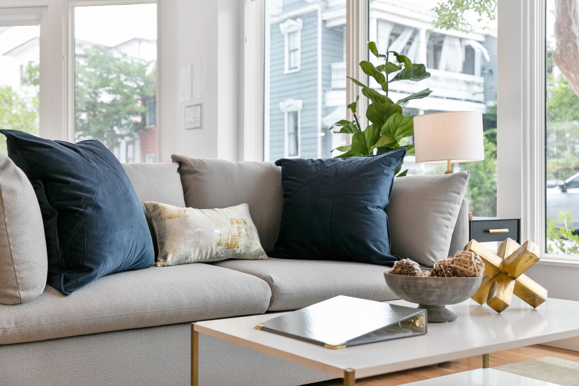 a grey sofa with blue cushions