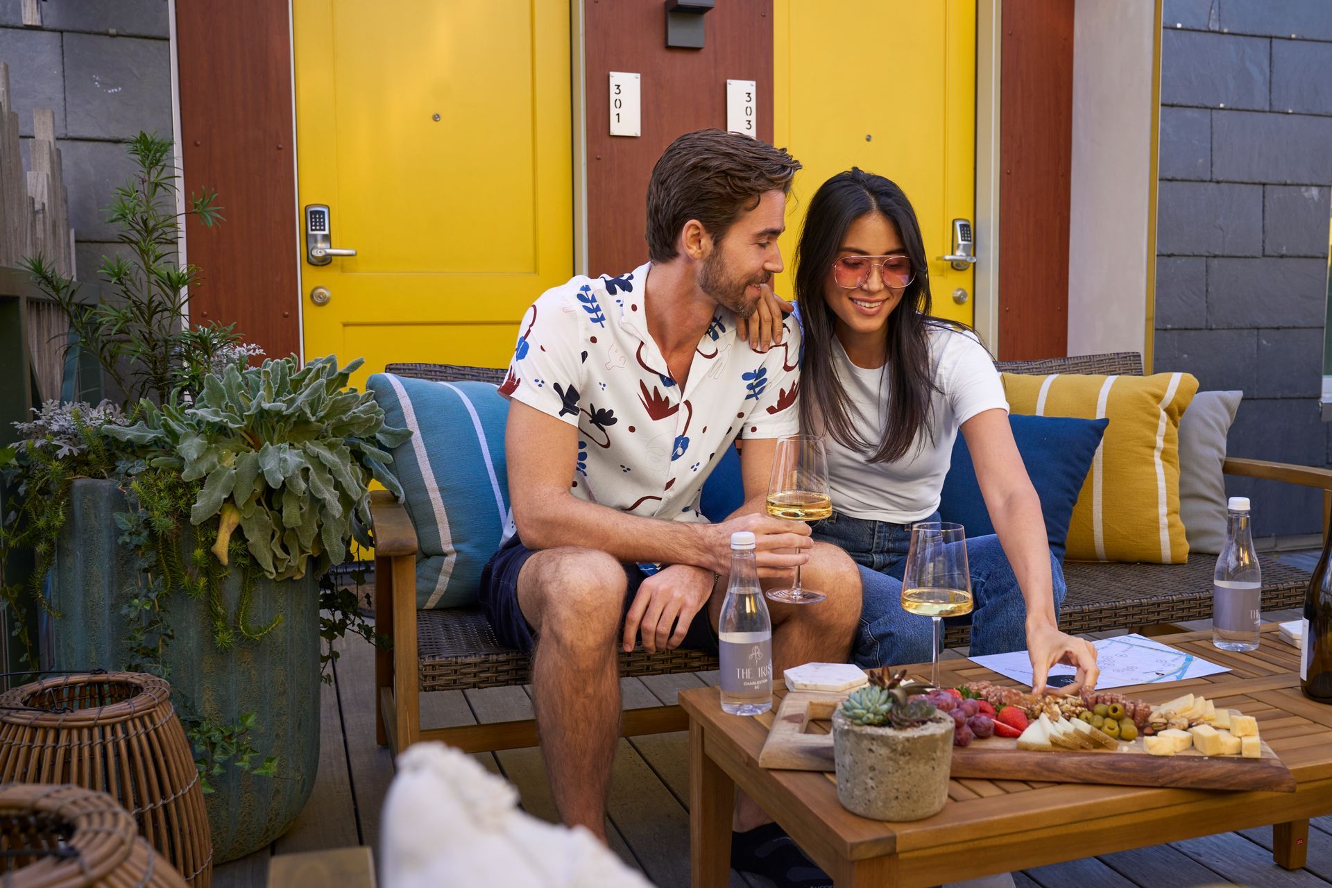 a couple enjoying wine and cheeseboard