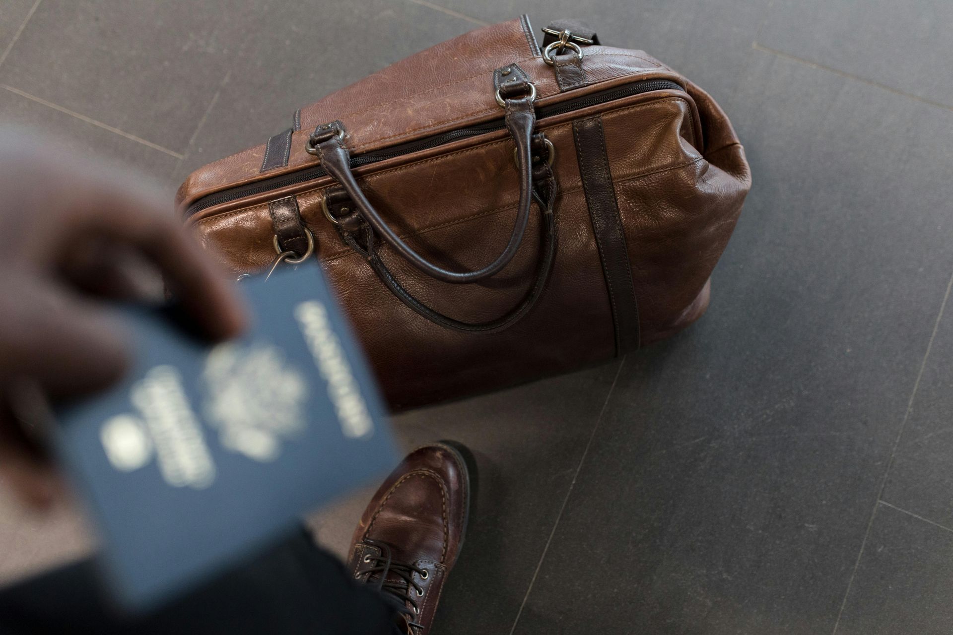 a person carrying their passport and luggage