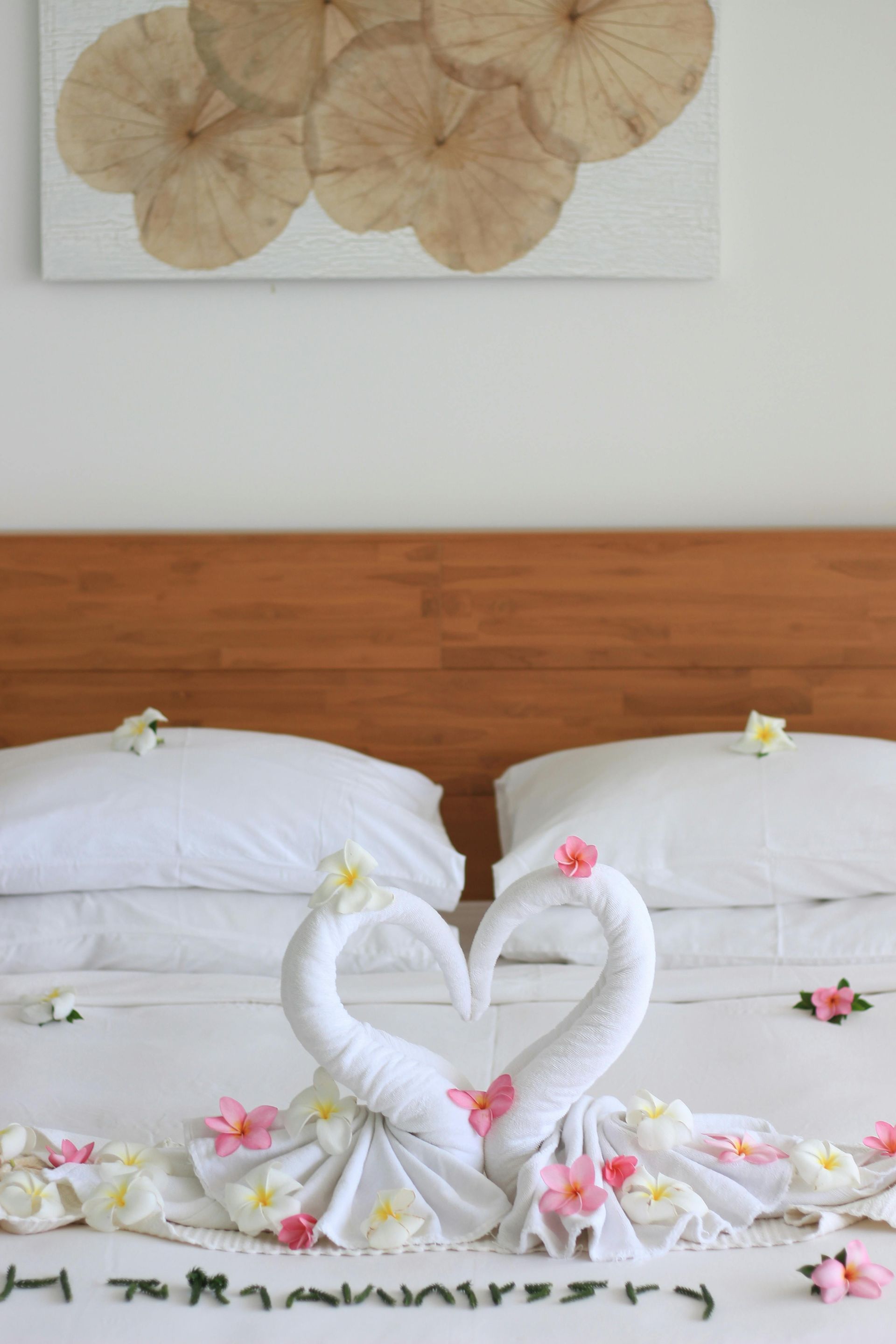 a towel swan at a hotel bed