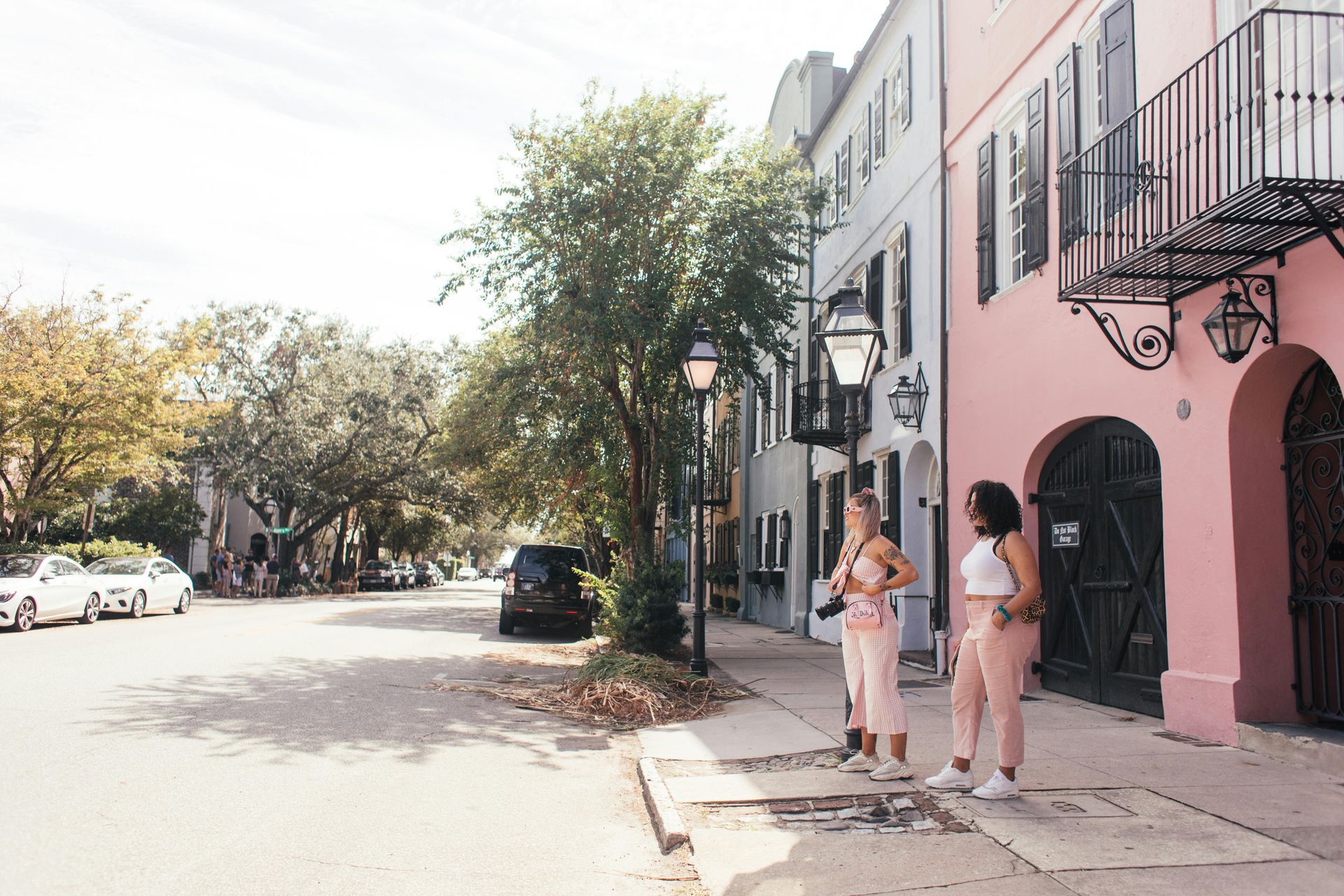 two girls standing on the pavement