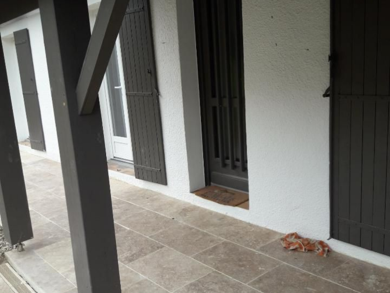 Une femme portant un bonnet rouge tient un appareil photo et prend une photo en extérieur.