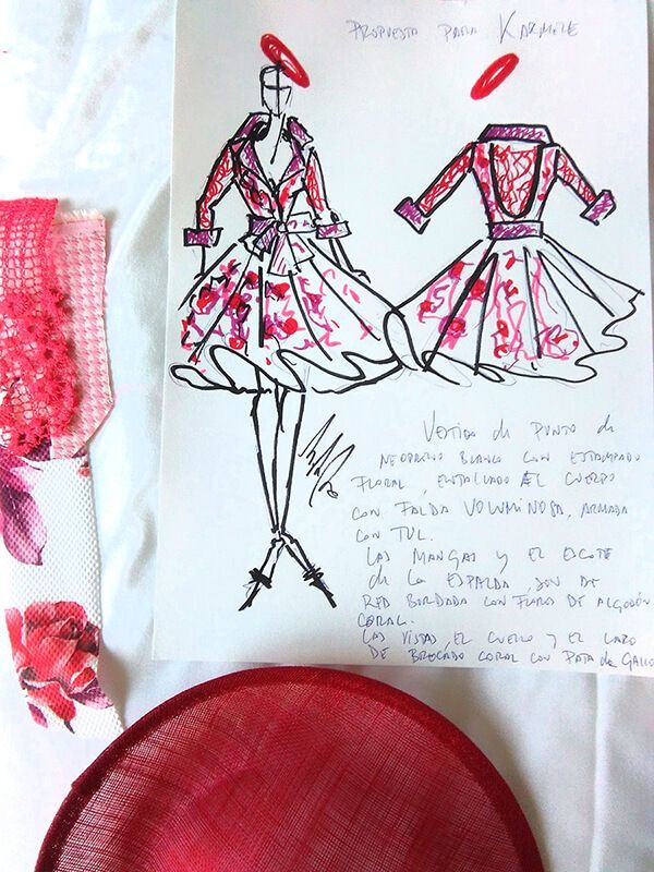 Un dibujo de un vestido rojo y blanco está en un trozo de papel.