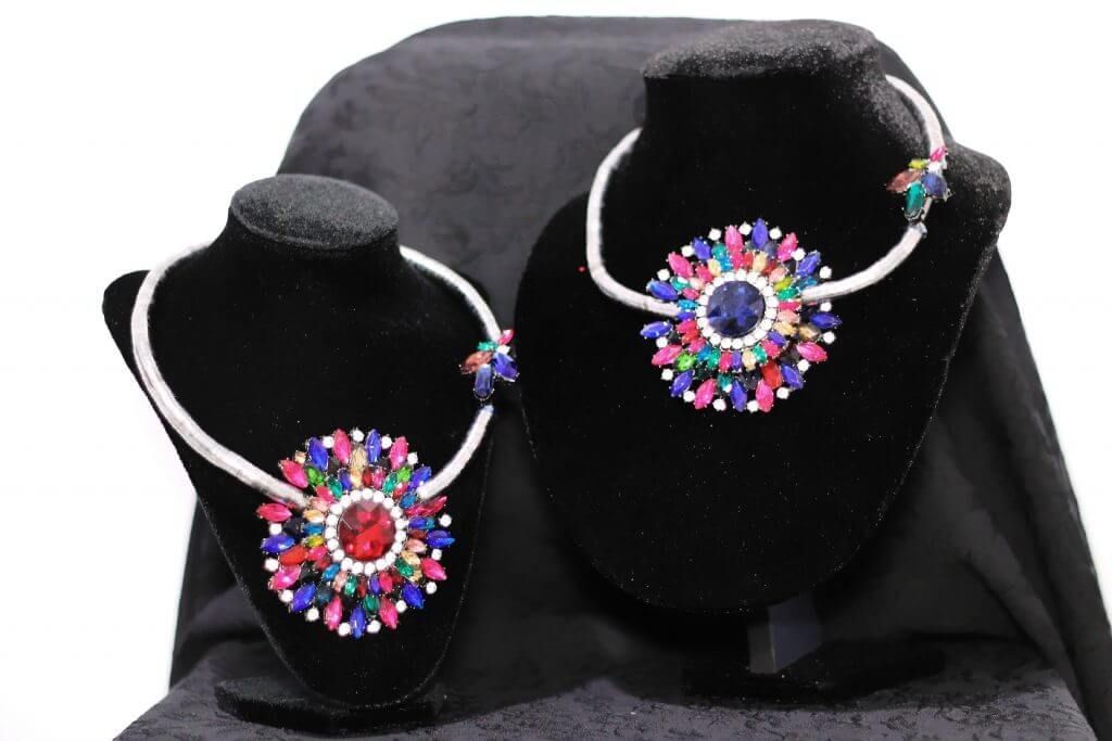 Dos maniquíes que llevan collares con cuentas de colores.