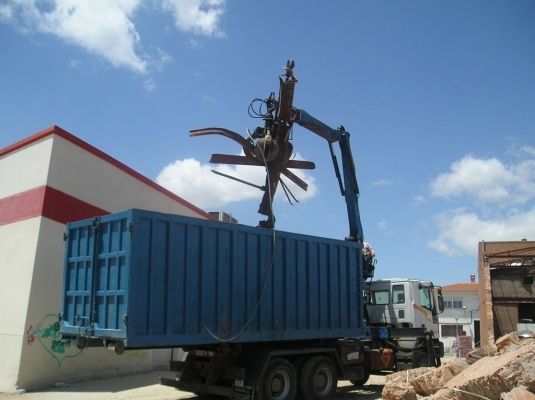 Un camión azul con una grúa acoplada.