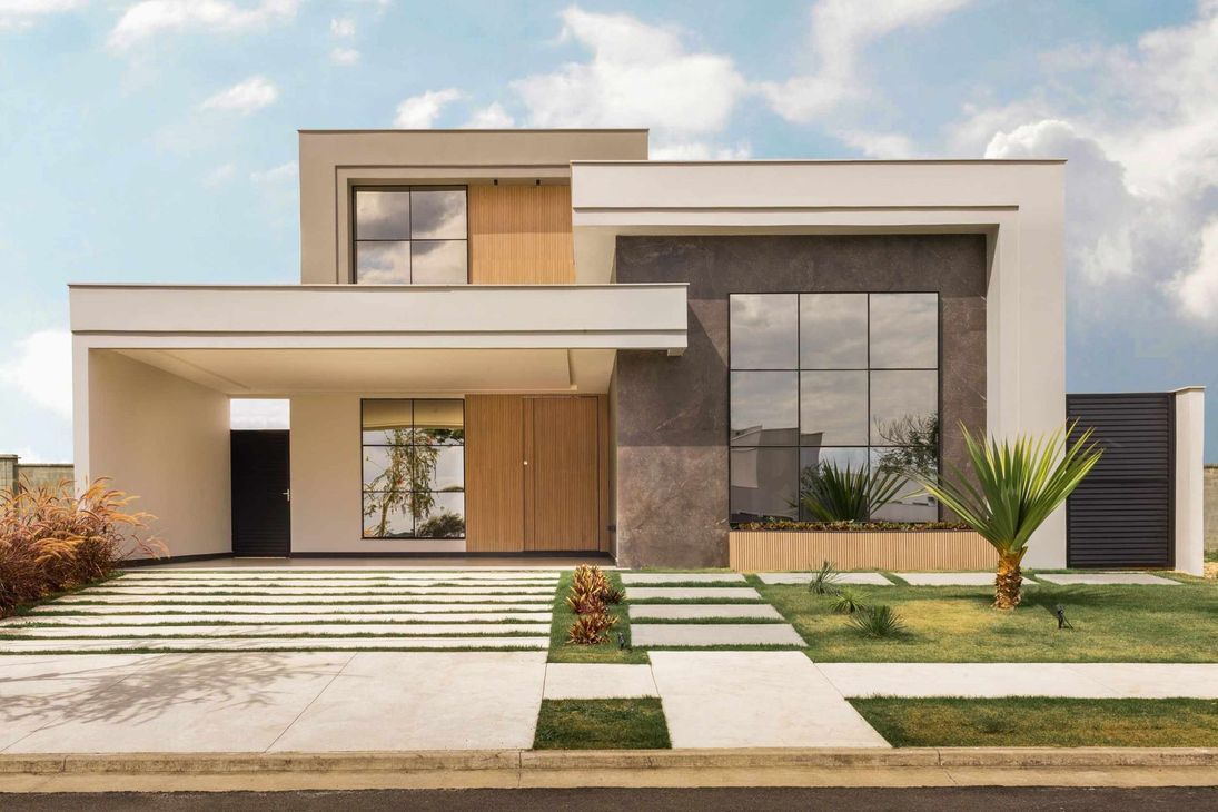Una casa moderna con muchas ventanas y escaleras.