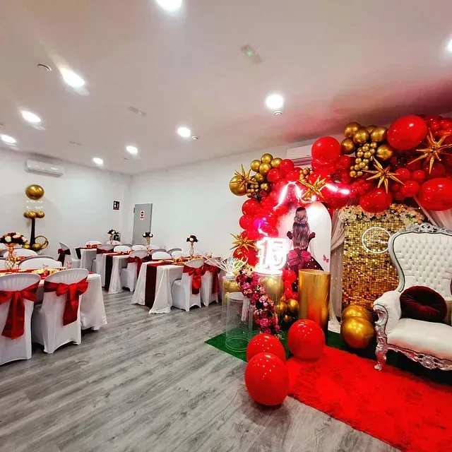 Una habitación llena de mesas y sillas decoradas para una fiesta de Navidad.