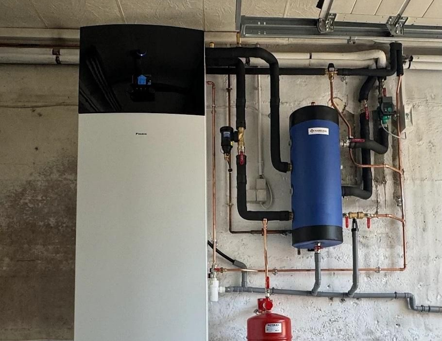 Système de pompe à chaleur blanc et noir avec un réservoir d'eau bleu.